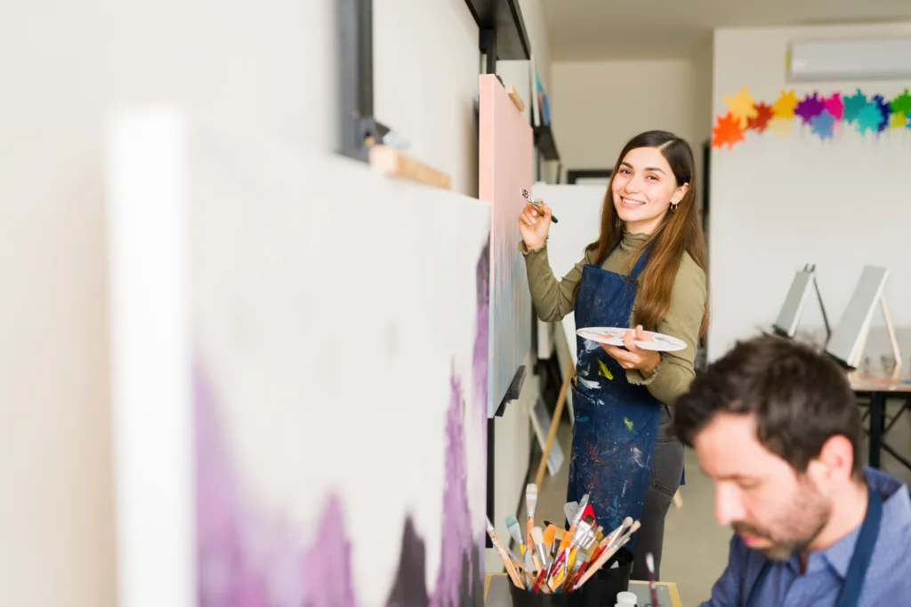 Portrait of a young woman happy to be taking an art class