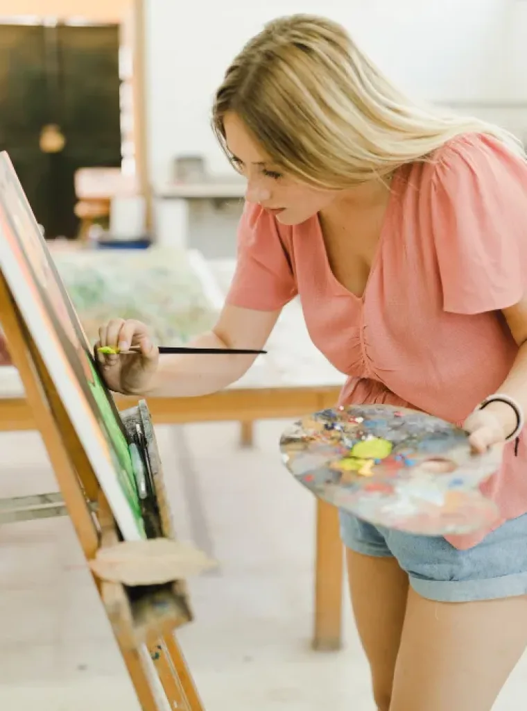 girl doing painting on art board